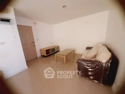 Spacious living room with modern furniture and neutral tones, perfect for relaxation.