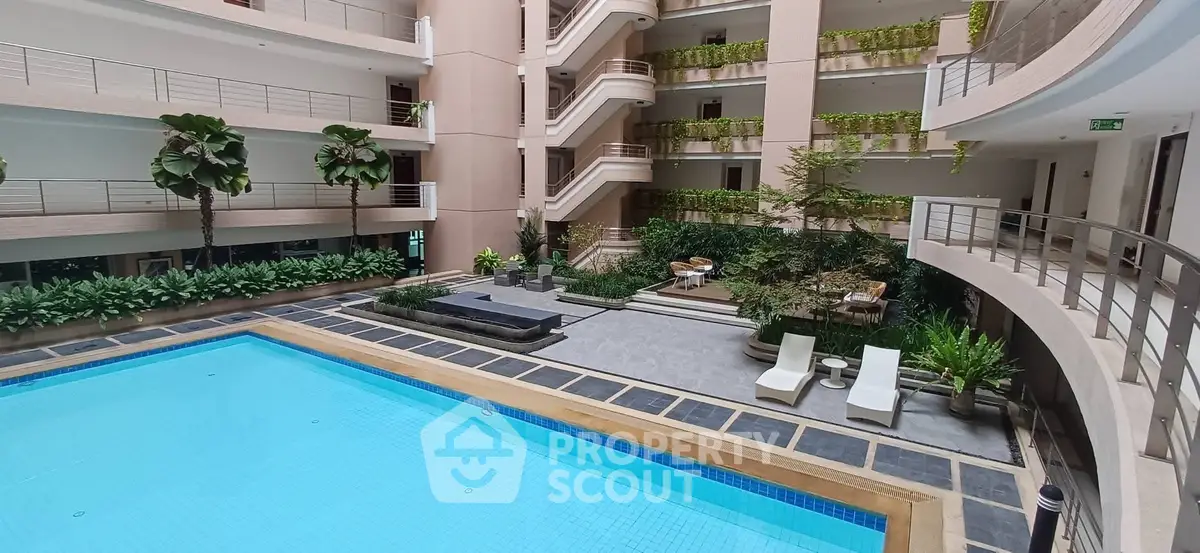 Luxurious indoor pool area with lush greenery and modern design in a high-end residential complex.