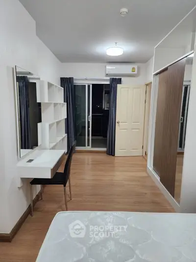 Modern bedroom with balcony access and stylish furniture