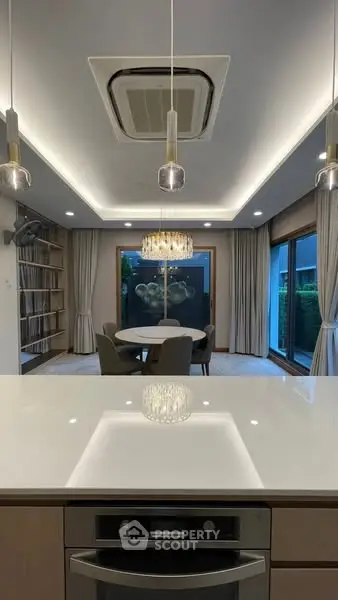 Modern dining area with elegant lighting and large windows