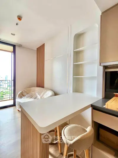 Modern kitchen with breakfast bar and city view from balcony