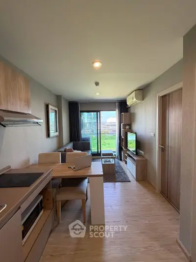 Modern living room with open kitchen and balcony view in stylish apartment