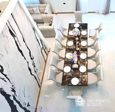 Luxurious dining room with elegant marble table and plush seating in a modern home