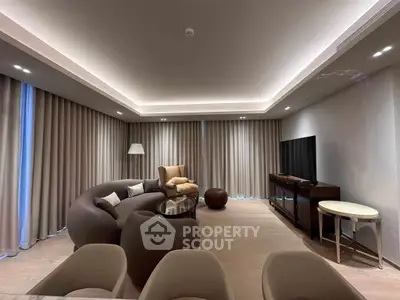 Luxurious modern living room with elegant lighting and stylish furniture, perfect for relaxation and entertainment.