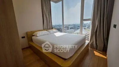 Cozy bedroom with panoramic city view and natural light