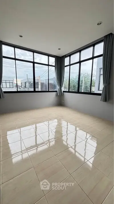 Spacious corner unit with large windows offering abundant natural light and modern tiled flooring.