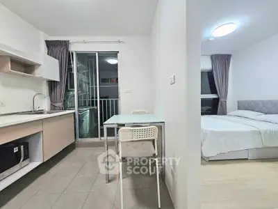 Modern studio apartment with open kitchen and cozy bedroom