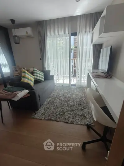 Modern living room with balcony access and stylish decor