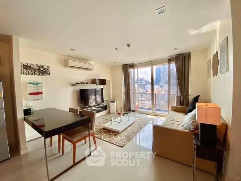 Modern living room with city view, stylish furniture, and natural light.