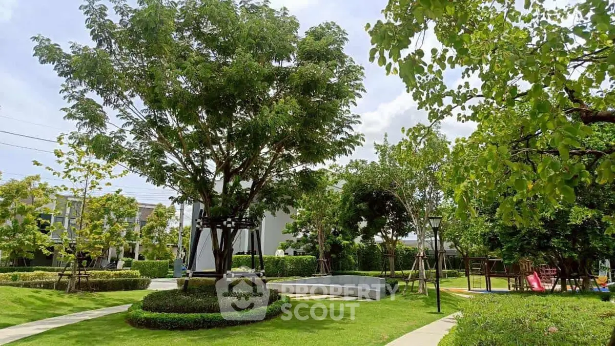Lush green garden with playground in a serene residential area