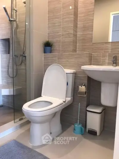 Modern bathroom with sleek fixtures and glass shower enclosure