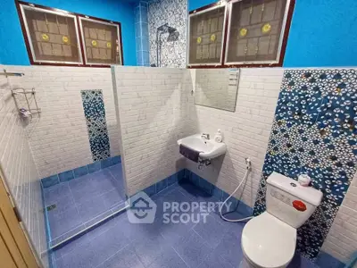 Modern bathroom with blue tiles and stylish mosaic accents