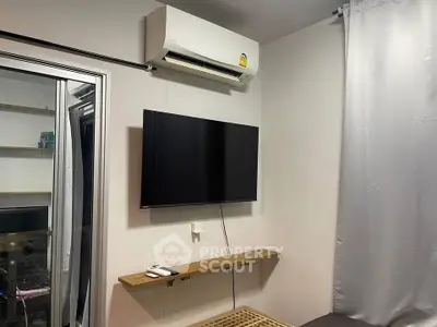 Modern living room with wall-mounted TV and air conditioning unit