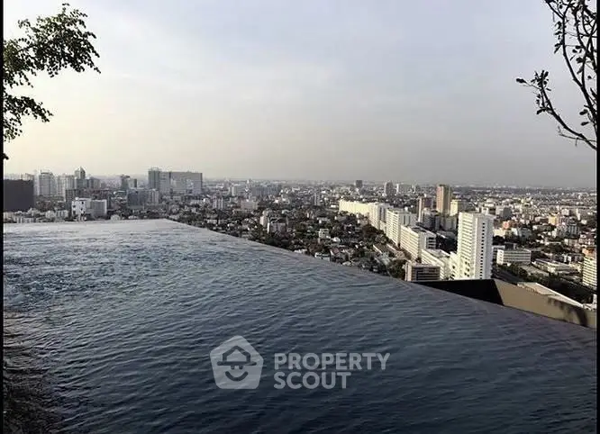 Stunning rooftop infinity pool with breathtaking city skyline view, perfect for luxury urban living.