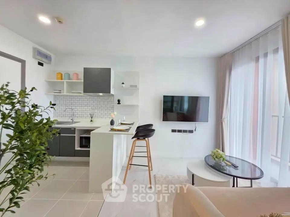 Modern open-layout living room with sleek kitchen and stylish decor