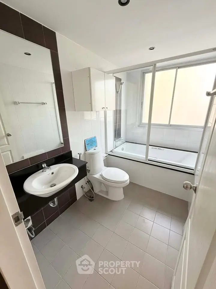 Modern bathroom with bathtub and sleek fixtures in a bright, airy space.