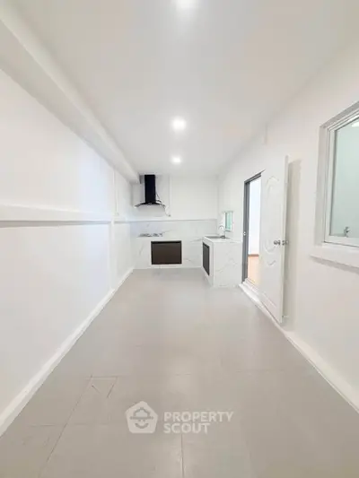 Spacious modern kitchen with sleek design and ample natural light