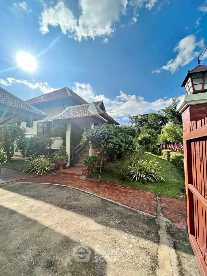 Charming suburban home with lush garden and sunny driveway, perfect for family living.