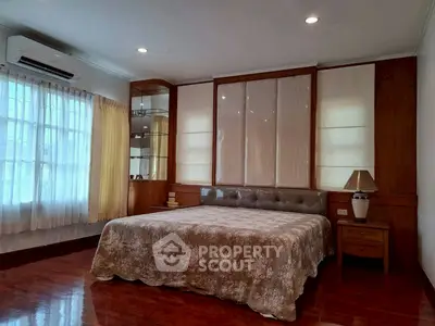 Spacious bedroom with elegant decor and natural light, featuring a comfortable bed and stylish furnishings.