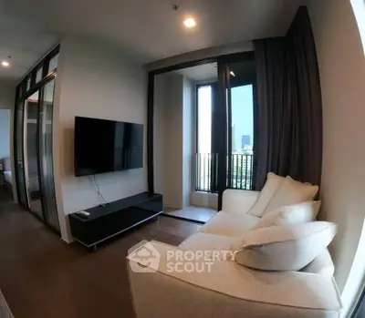 Modern living room with cozy sofa and wall-mounted TV, featuring a small balcony with city view.