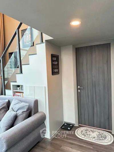 Modern duplex interior with stylish staircase and cozy living area