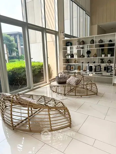 Stylish modern living room with unique rattan furniture and large windows.