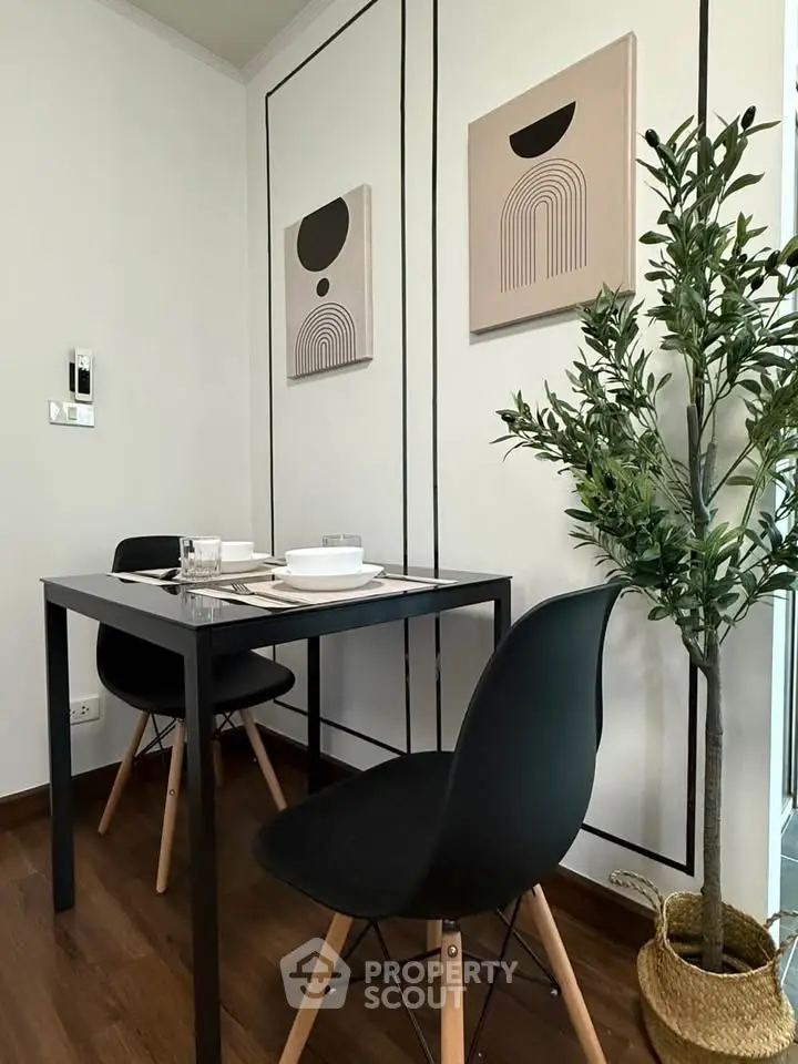 Modern dining area with minimalist decor and stylish black chairs