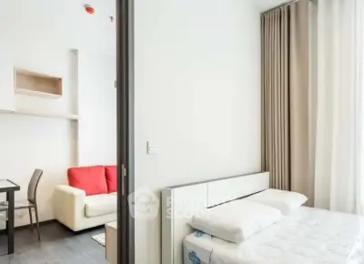 Modern studio apartment with cozy living area and comfortable bed