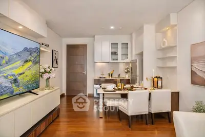 Modern living room with open kitchen, elegant dining area, and stylish decor in a cozy apartment.