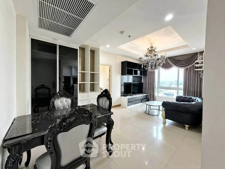 Luxurious living room with elegant chandelier and classic furniture, offering a stunning city view.