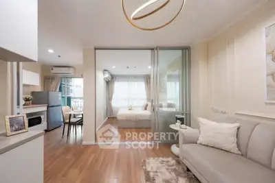 Modern open-plan living room with cozy decor and sliding glass doors to bedroom