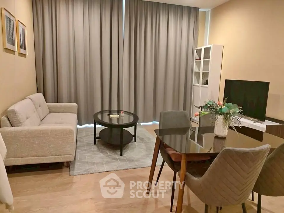Modern living room with cozy sofa, elegant dining set, and stylish decor in a contemporary apartment.