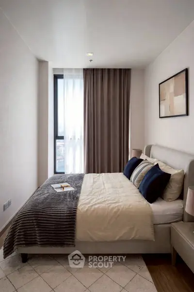 Modern bedroom with stylish decor and large window for natural light