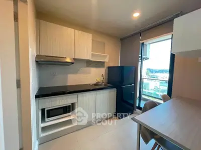 Modern kitchen with sleek cabinetry and large window view