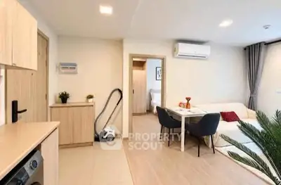 Modern open-plan living room with dining area and air conditioning