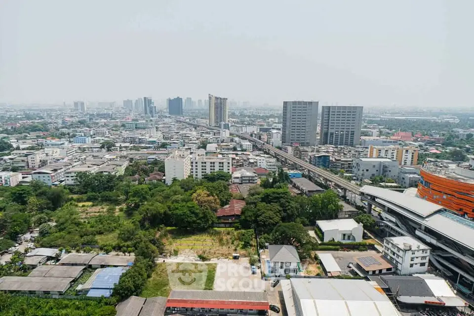 Stunning aerial view of urban landscape with modern high-rise buildings and lush greenery, perfect for real estate investment.