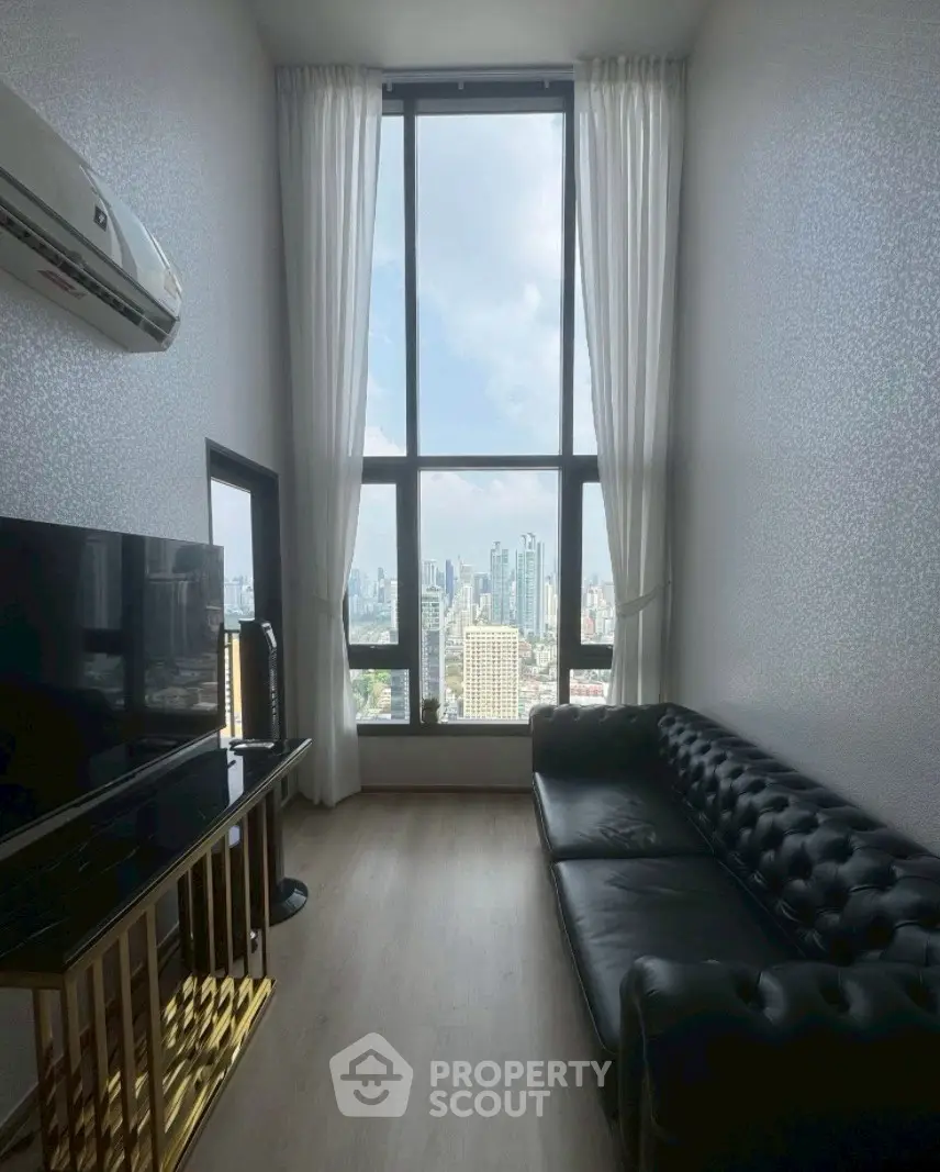 Luxurious high-rise living room with stunning city view and elegant decor.