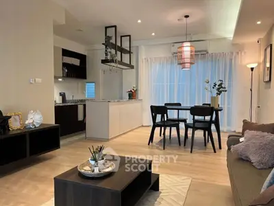 Modern open-plan living room with stylish dining area and contemporary kitchen design.