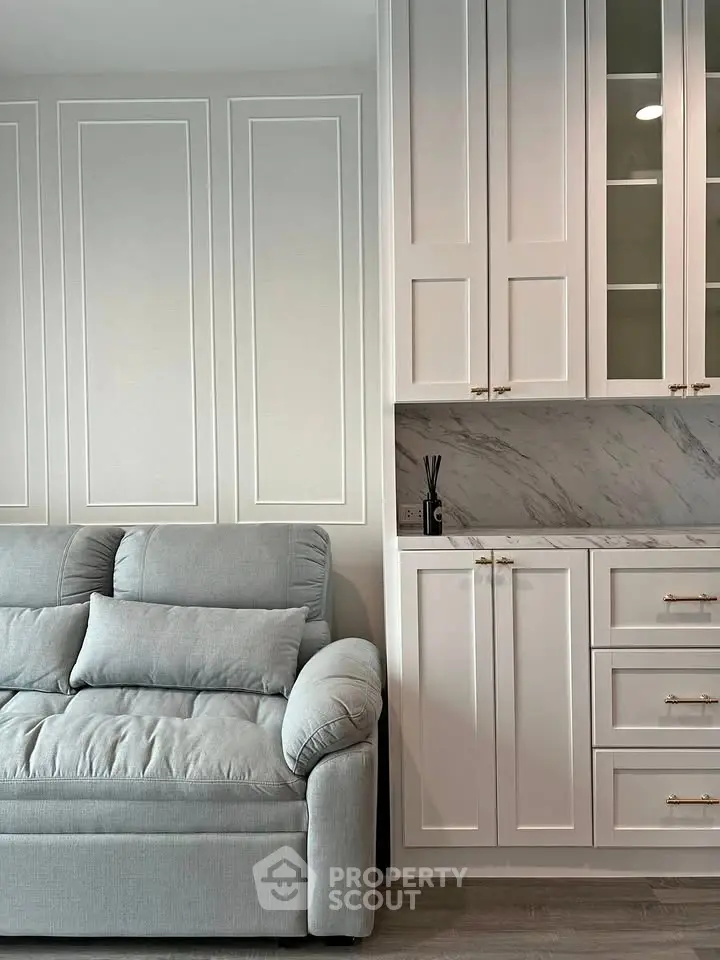 Elegant living room with plush sofa and stylish cabinetry