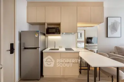 Modern compact kitchen with sleek cabinetry and integrated appliances in a stylish apartment.