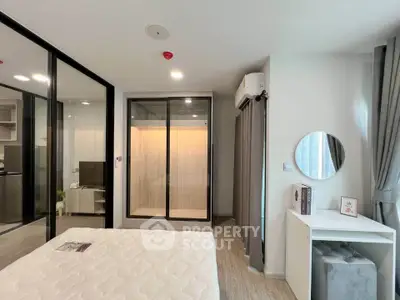 Modern bedroom with mirrored closet and stylish decor in a contemporary apartment.