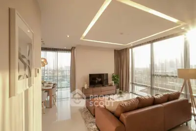 Luxurious living room with modern decor and stunning city view, featuring a spacious layout and elegant furnishings.