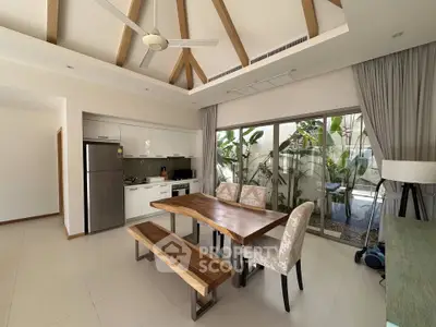 Modern kitchen with open layout and stylish dining area, featuring wooden table and garden view.