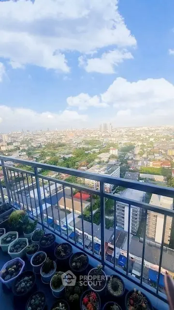 Stunning high-rise balcony view with cityscape and potted plants, perfect for urban living enthusiasts.