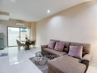 Spacious modern living room with cozy sectional sofa and dining area, perfect for relaxation and entertaining.
