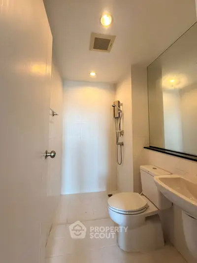 Modern bathroom with sleek fixtures and spacious shower area.