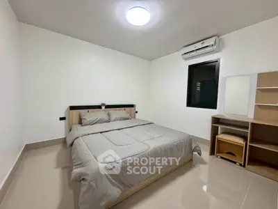 Modern minimalist bedroom with sleek furniture and air conditioning