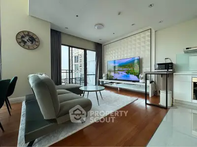 Modern living room with stylish decor, large TV, and balcony view in a contemporary apartment.