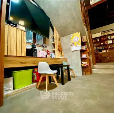 Charming modern living area with stylish decor and entertainment setup