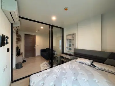 Modern bedroom with glass partition and stylish decor in a contemporary apartment.